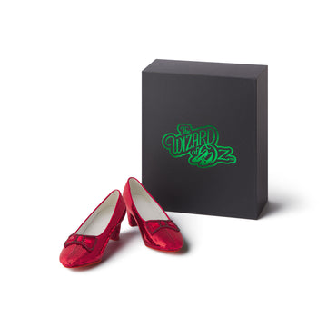 Red shoes and a black box with 'The Wizard of Oz' logo Ruby Slipper Replica shoes on a white background